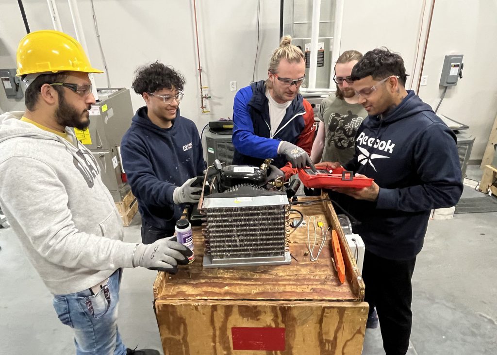 Hands-on HVAC training with an instructor